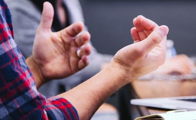 Close-up of hands mid discussion