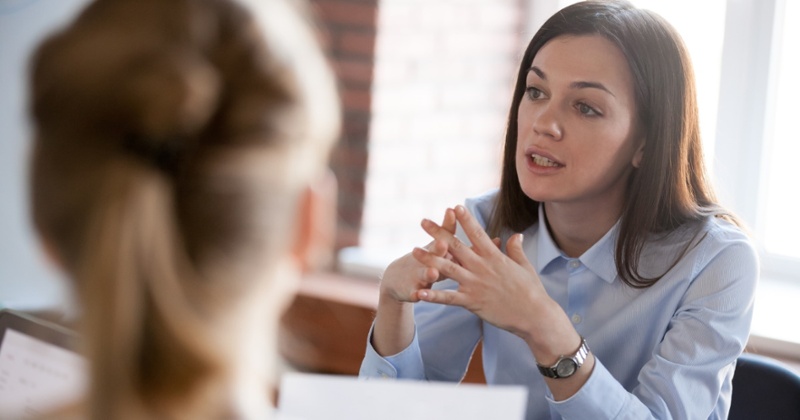 Woman discussing with employee