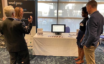 Simon Laxton at HR Network's annual meet-up with 3 prospects around Workpro's stand