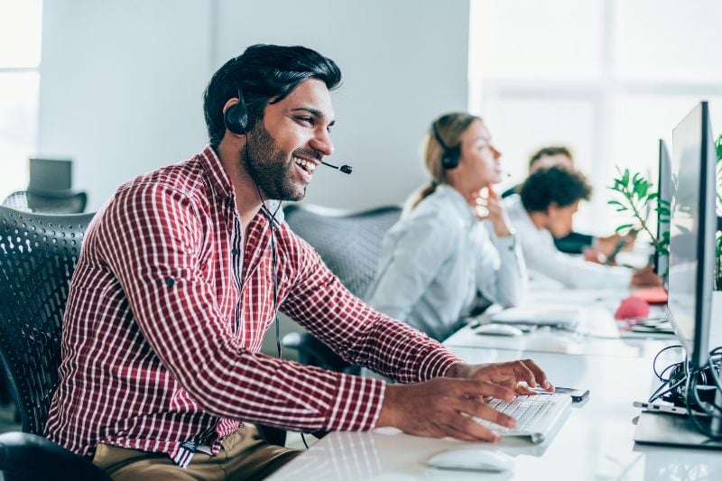 Happy man working in call centre