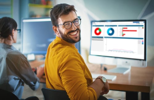 A young adult smiling at the camera with a screenshot of Workpro at the back of the image