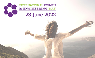 A woman with her arms wide at the top of a hill for International Woman in Engineering Day 2022.